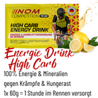 NOM Competition High Carb Energy Drinks, speziell für Rennen und intensives Training. Verpackung zeigt einen Radfahrer, begleitet von Zitronen und Spritzwasser."